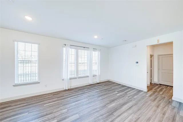 a kitchen with a sink and wooden floor
