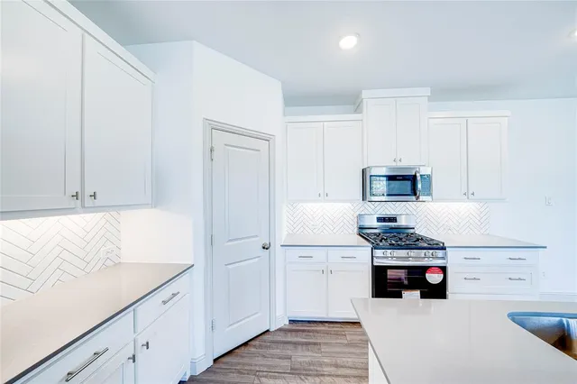 a kitchen with a sink stove and refrigerator