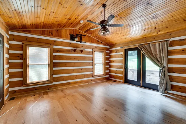 a view of house with backyard and outdoor seating