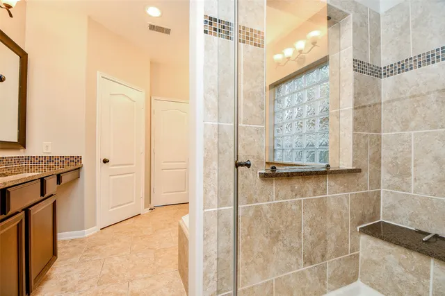 a bathroom with a bathtub and shower