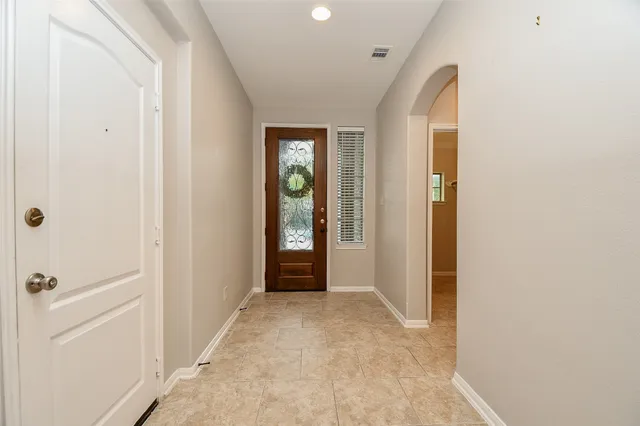 a view of a hallway with wooden shelves