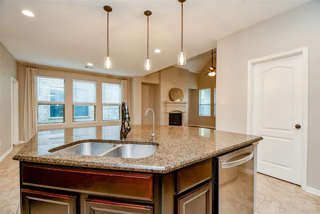 a kitchen with stainless steel appliances granite countertop a sink and stove top oven