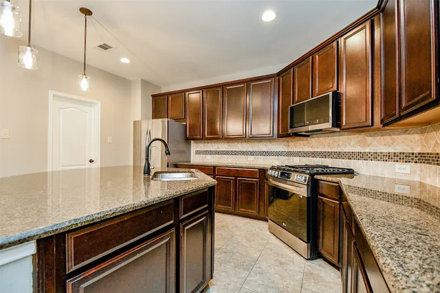 a view of an empty room with a fireplace and a window