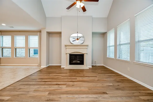 a view of empty room with a fireplace and fan