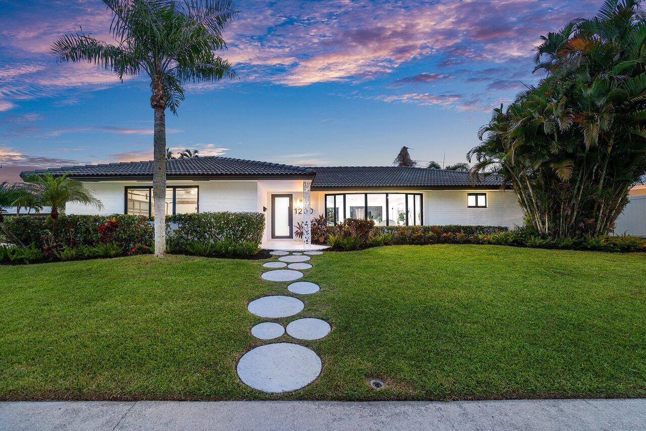 a front view of house with yard and outdoor seating