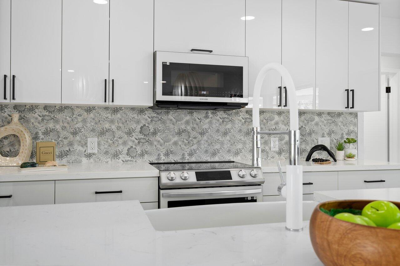 1200 Southwest 8th Street Boca Raton, FL 33486 - Photo 16 of 42 a kitchen with a stove and a microwave
