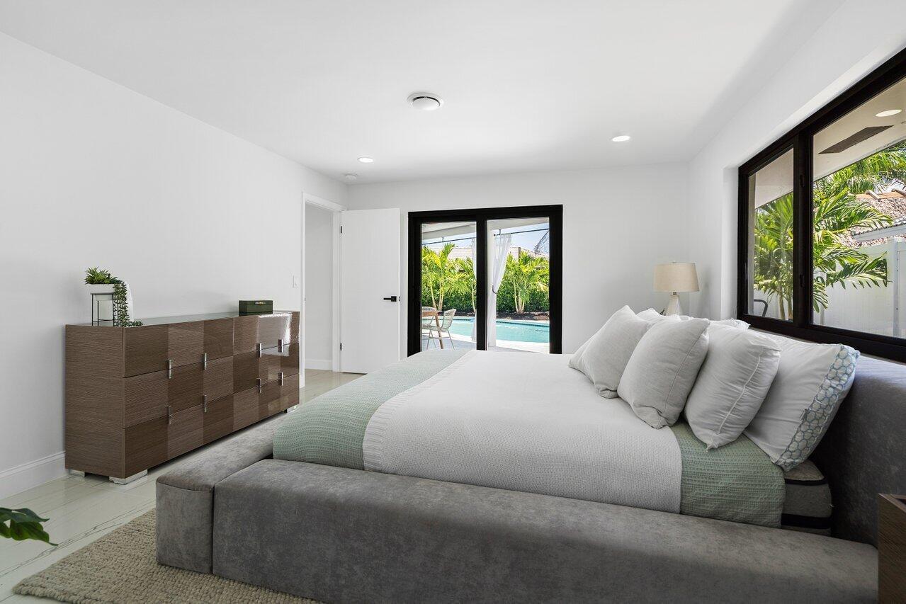 1200 Southwest 8th Street Boca Raton, FL 33486 - Photo 20 of 42 a bedroom with furniture and a large window