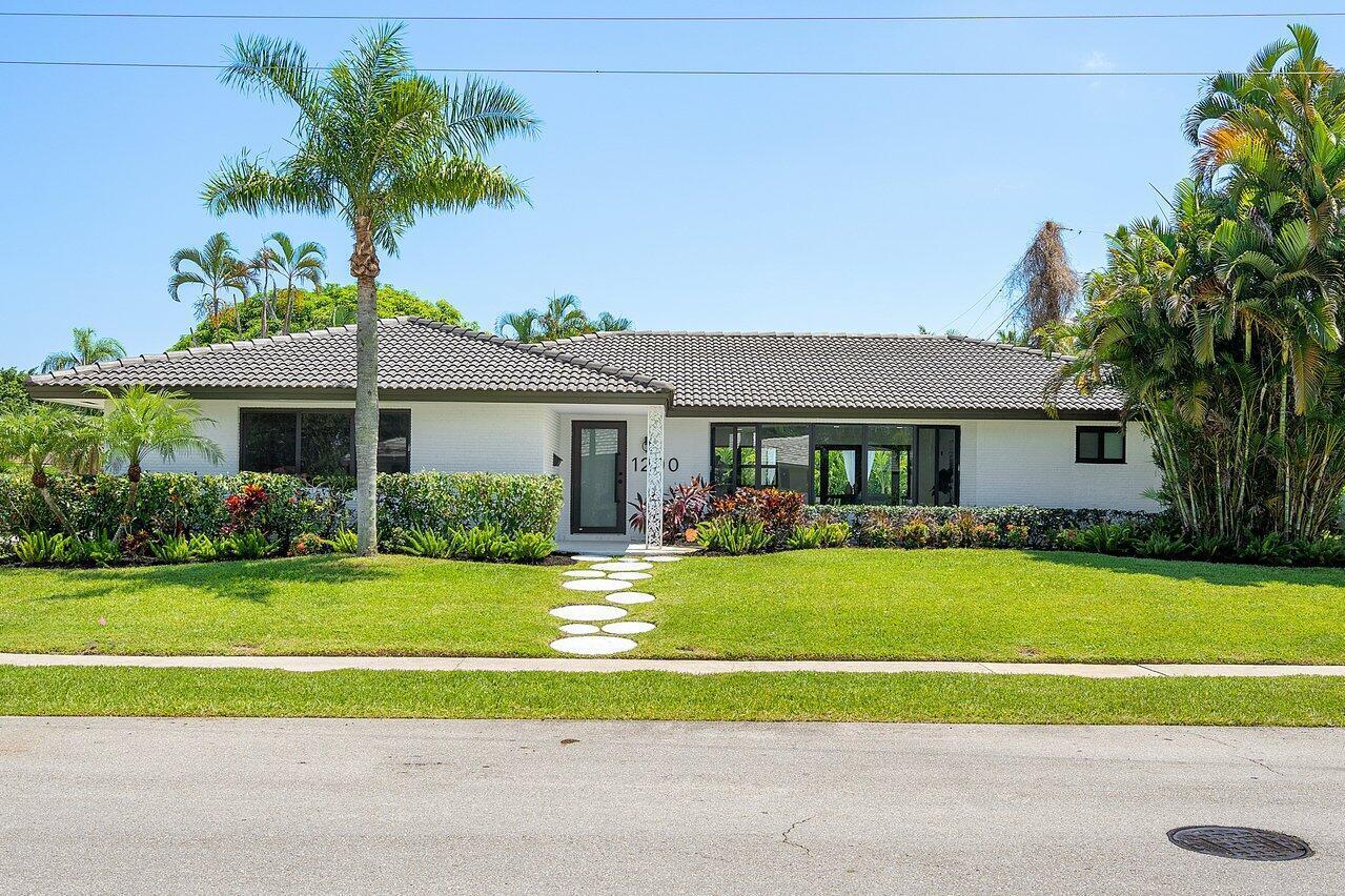 1200 Southwest 8th Street Boca Raton, FL 33486 - Photo 2 of 42 a front view of a house with a yard table and chairs