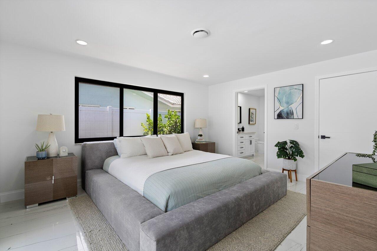 1200 Southwest 8th Street Boca Raton, FL 33486 - Photo 24 of 42 a bedroom with a large bed and a large window