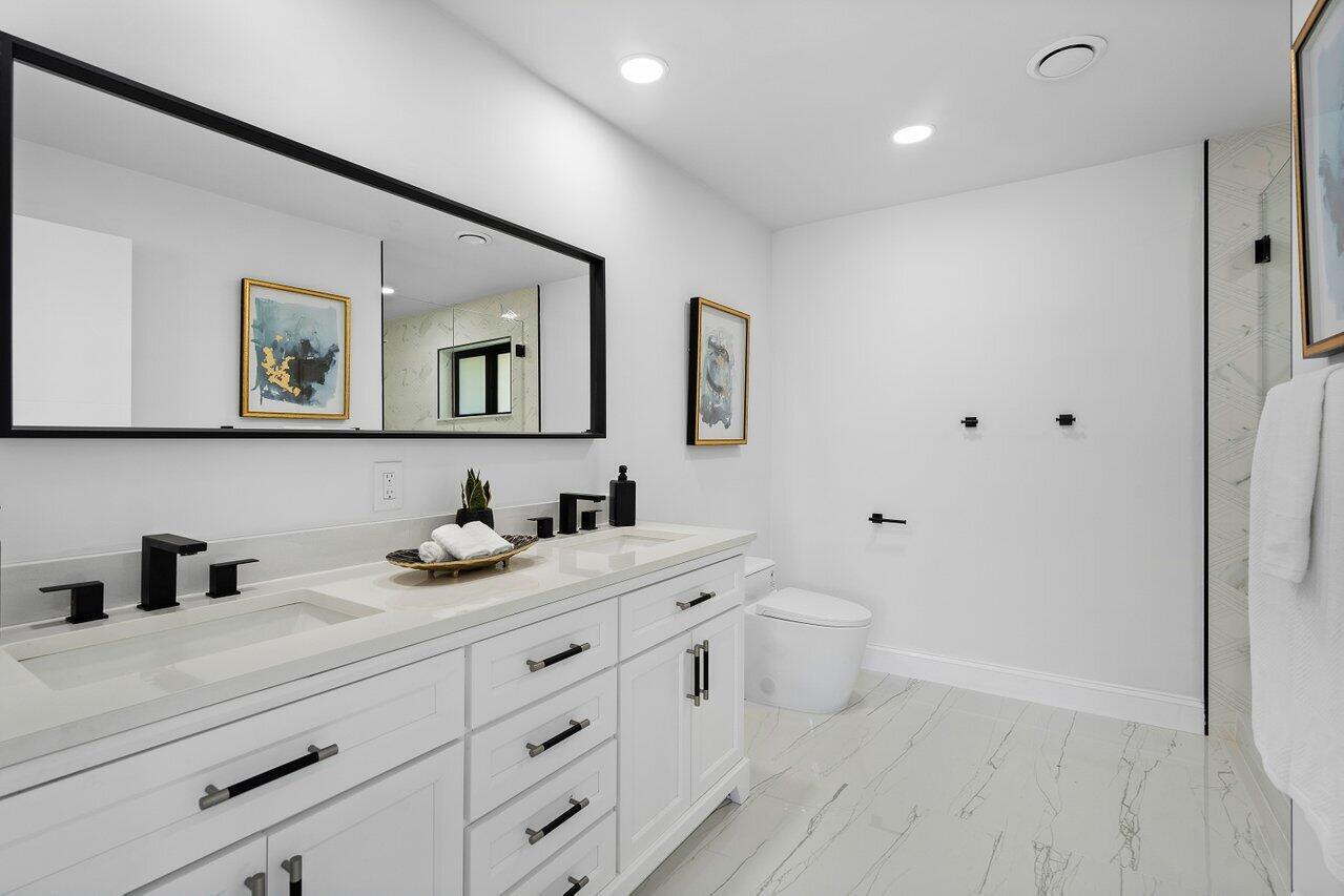 1200 Southwest 8th Street Boca Raton, FL 33486 - Photo 25 of 42 a bathroom with a toilet sink and mirror