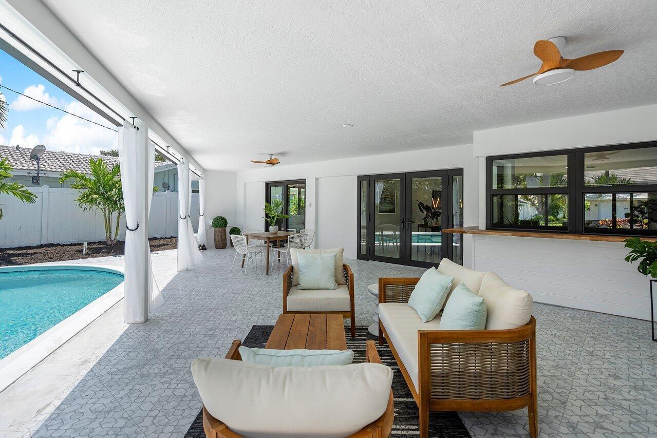 1200 Southwest 8th Street Boca Raton, FL 33486 - Photo 28 of 42 a living room with furniture and a swimming pool