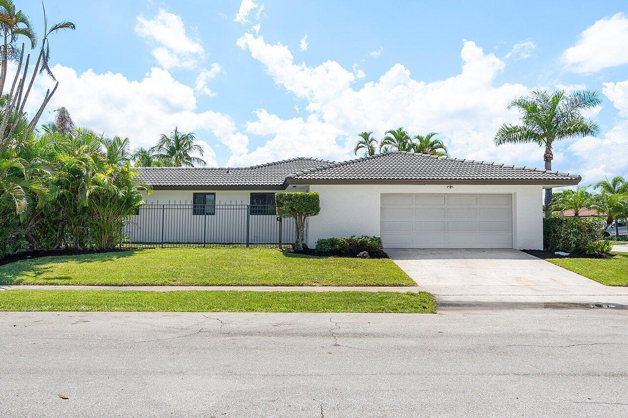 1200 Southwest 8th Street Boca Raton, FL 33486 - Photo 3 of 42 a view of a house with a yard and a garage