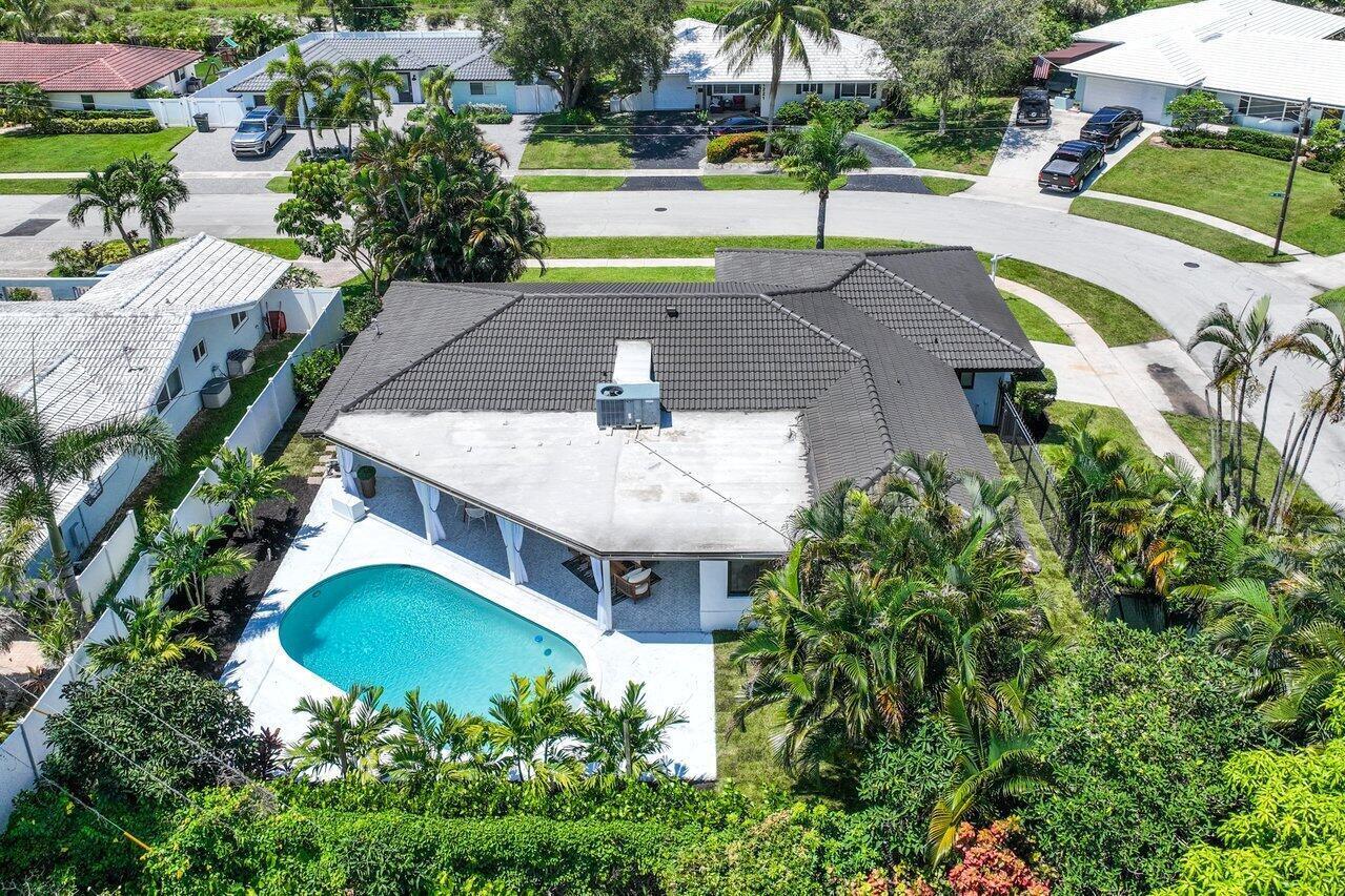 1200 Southwest 8th Street Boca Raton, FL 33486 - Photo 33 of 42 an aerial view of a house with swimming pool and large trees
