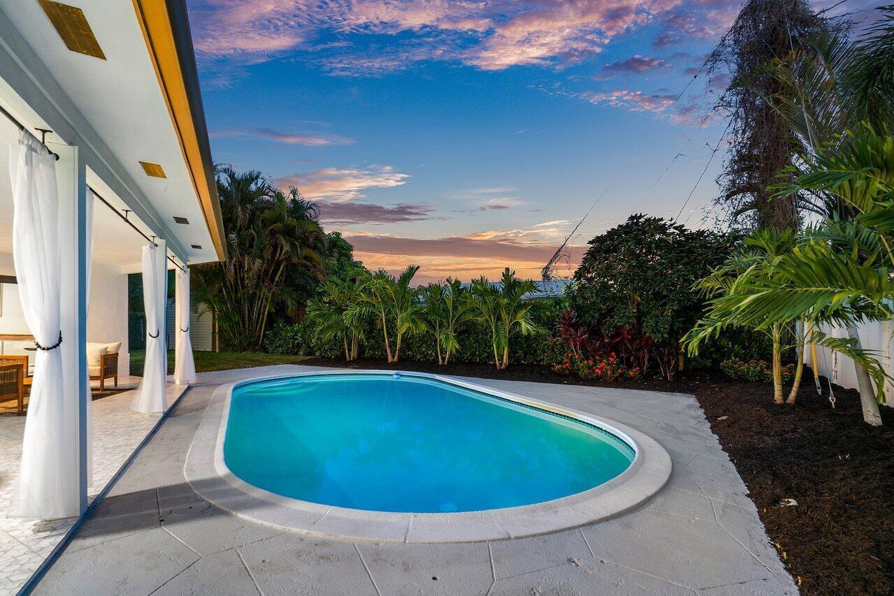 1200 Southwest 8th Street Boca Raton, FL 33486 - Photo 37 of 42 a view of a swimming pool with an outdoor seating