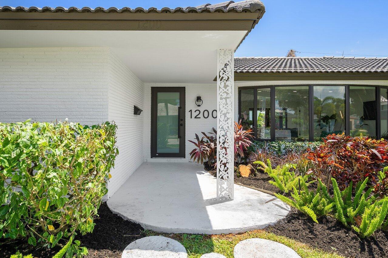 1200 Southwest 8th Street Boca Raton, FL 33486 - Photo 4 of 42 a view of a patio with table and chairs potted plants