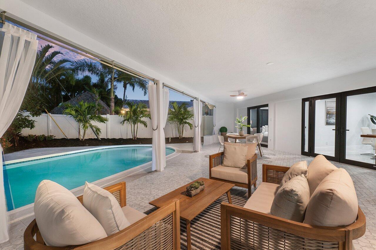 1200 Southwest 8th Street Boca Raton, FL 33486 - Photo 42 of 42 a living room with furniture and a floor to ceiling window