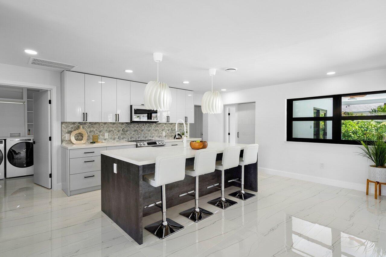 1200 Southwest 8th Street Boca Raton, FL 33486 - Photo 10 of 42 a kitchen with a sink a table and chairs