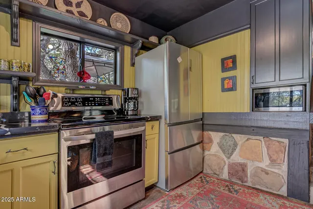 a kitchen with stainless steel appliances granite countertop a stove and a microwave
