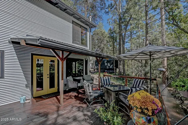 a view of sitting area with chairs and table in the patio