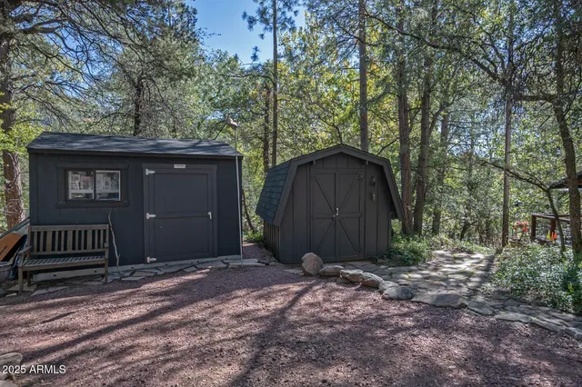 a view of a house with a yard and wooden fence