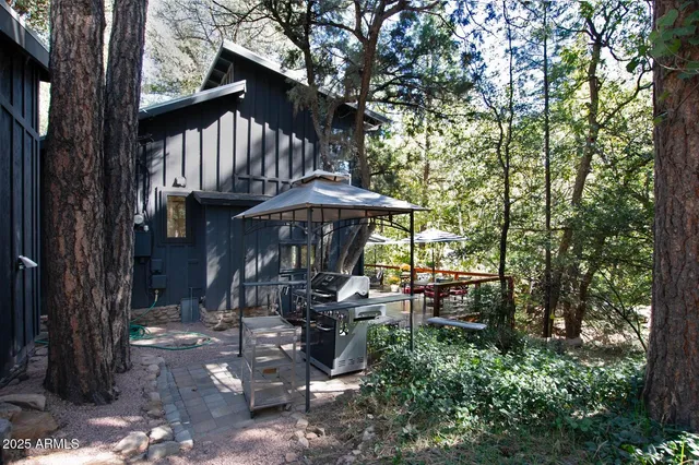 a view of a patio with table and chairs under an umbrella
