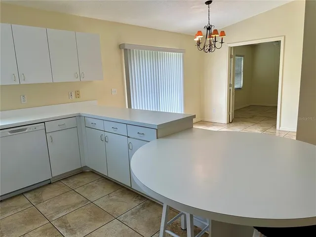 a kitchen with a sink appliances and cabinets
