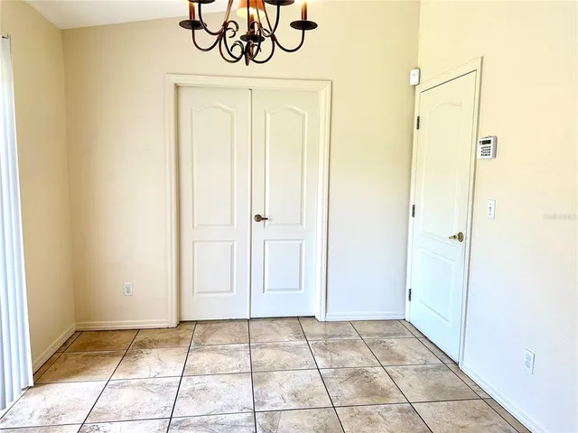 a view of a hallway with a chandelier
