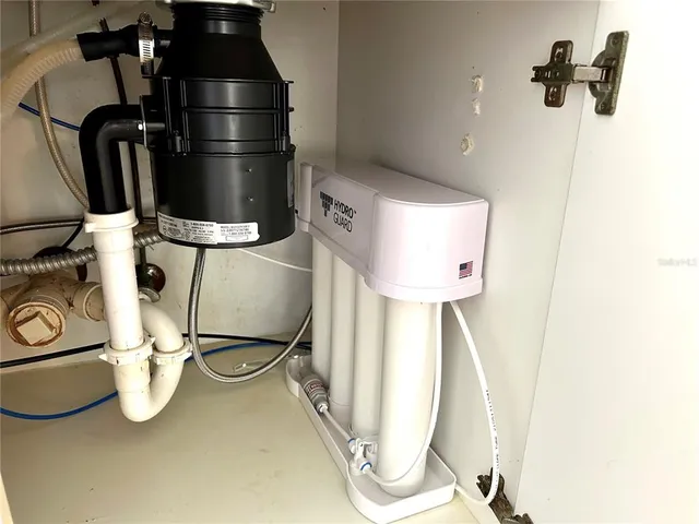 a view of a house with pool and chairs