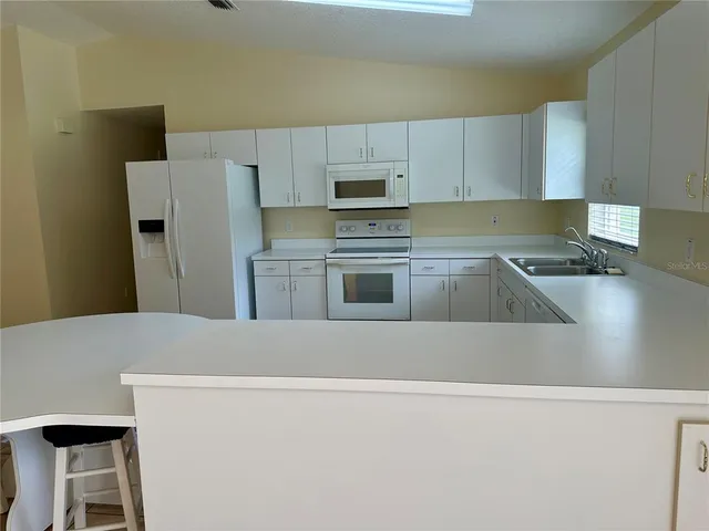 a kitchen with cabinets and steel stainless steel appliances