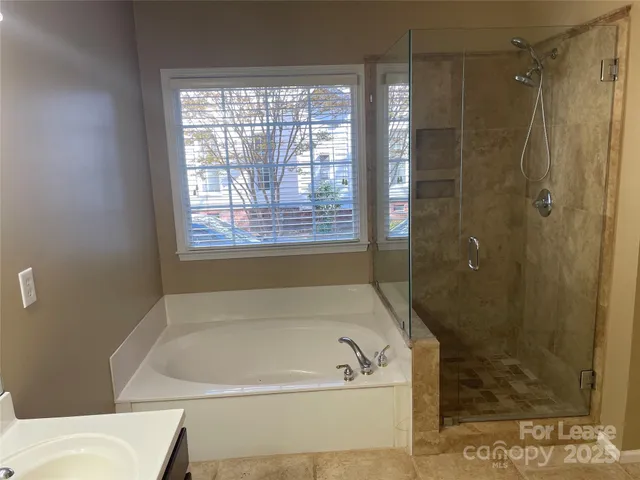 a bath tub sitting next to a window