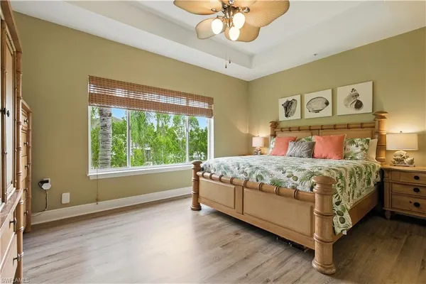 a bedroom with a large bed and a large window