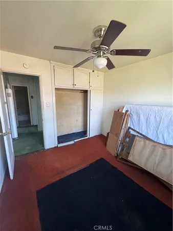 a bedroom with a bed and a mirror
