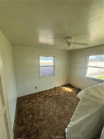 a bedroom with a bed and window