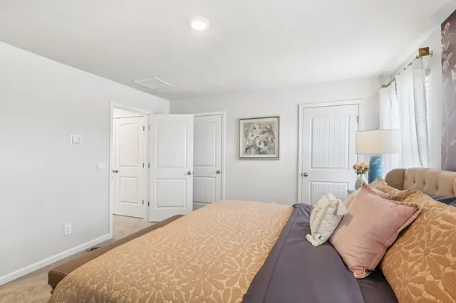 a bedroom with a bed and a lamp