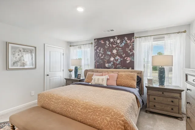 a bedroom with a large bed and a window