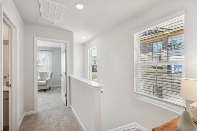 a view of hallway with livingroom and furniture