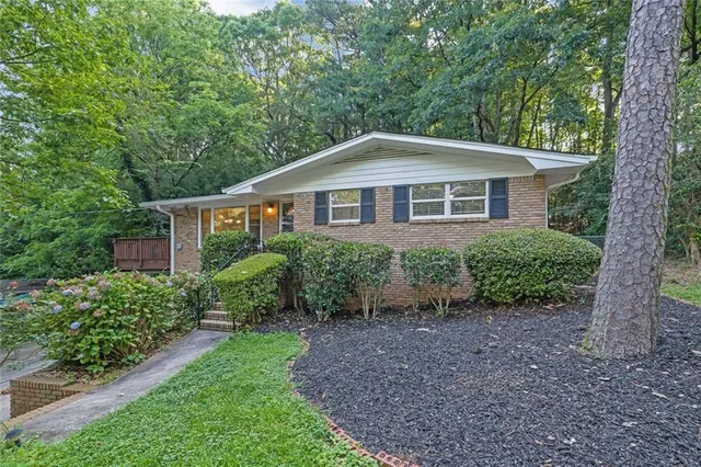 a front view of a house with a garden