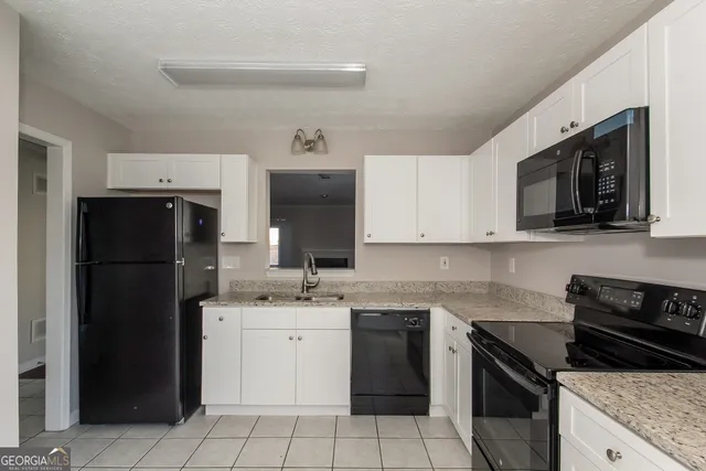a kitchen with a sink stove and refrigerator