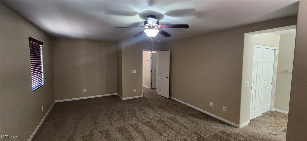 10211 Glimmering Star Drive Las Vegas, NV 89178 - Photo 11 of 33 Empty room featuring a ceiling fan and carpet