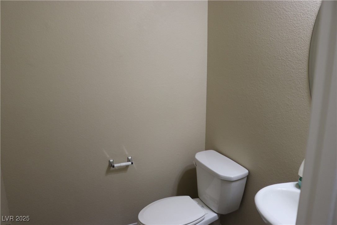 10211 Glimmering Star Drive Las Vegas, NV 89178 - Photo 15 of 33 Bathroom with toilet and a textured wall