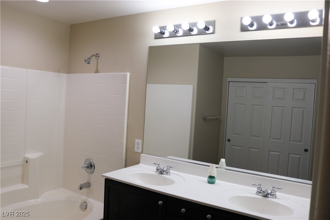 10211 Glimmering Star Drive Las Vegas, NV 89178 - Photo 16 of 33 Bathroom featuring double vanity and shower / tub combination