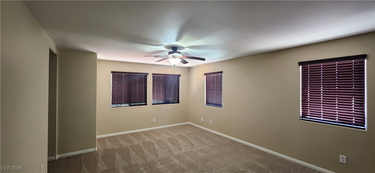 10211 Glimmering Star Drive Las Vegas, NV 89178 - Photo 19 of 33 Carpeted spare room with a ceiling fan and baseboards