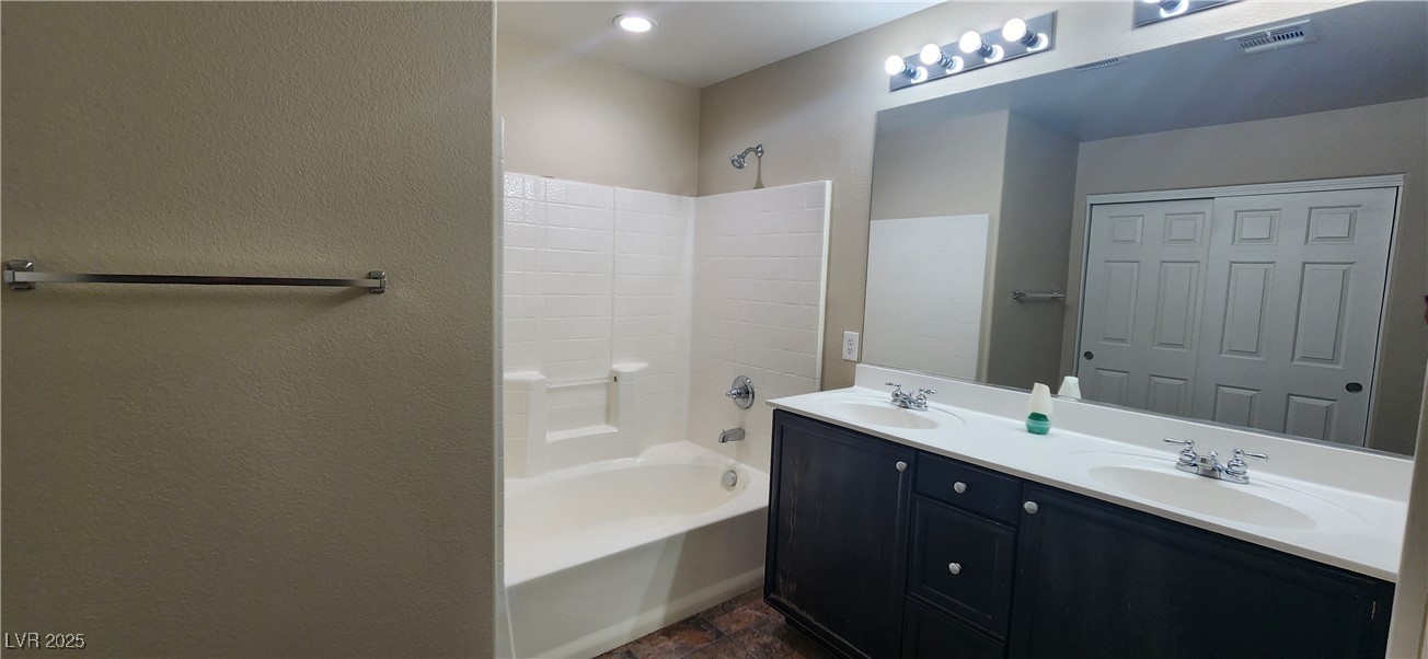 10211 Glimmering Star Drive Las Vegas, NV 89178 - Photo 20 of 33 Full bathroom with shower / bathtub combination, double vanity, and a textured wall