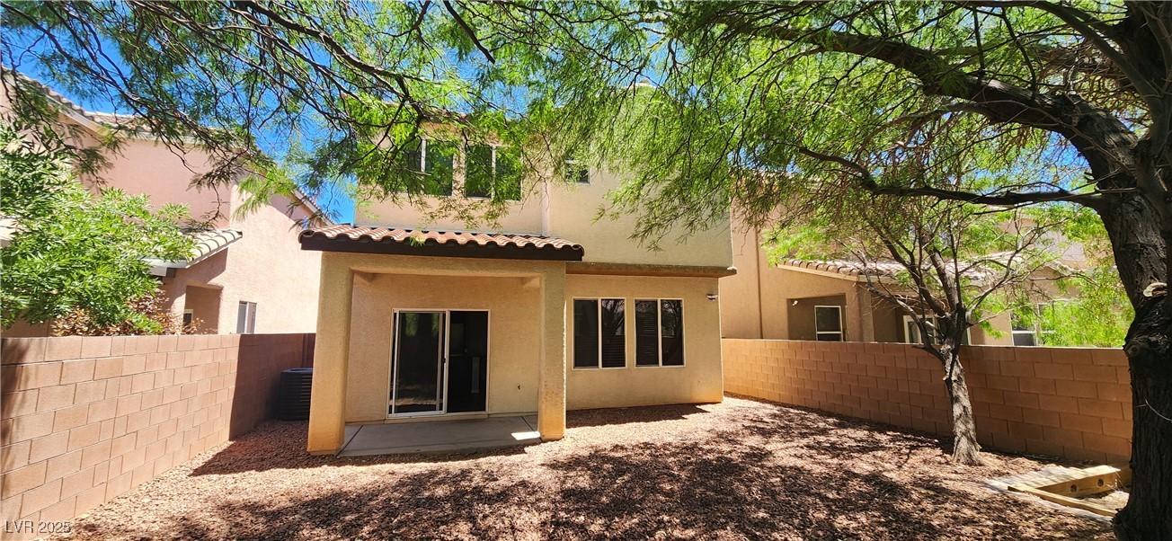 10211 Glimmering Star Drive Las Vegas, NV 89178 - Photo 24 of 33 Rear view of house featuring a fenced backyard, a tiled roof, and stucco siding