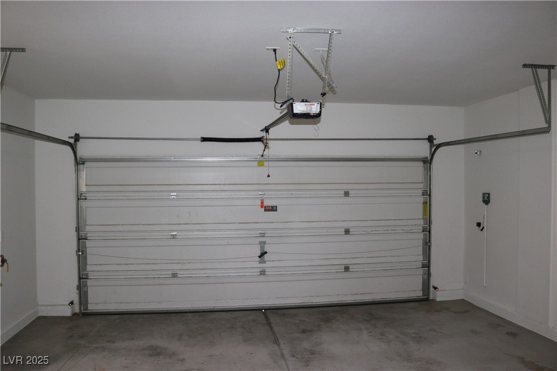 10211 Glimmering Star Drive Las Vegas, NV 89178 - Photo 31 of 33 Garage featuring baseboards and a garage door opener