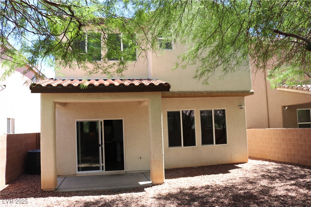 10211 Glimmering Star Drive Las Vegas, NV 89178 - Photo 32 of 33 Rear view of house with a tile roof, stucco siding, and a patio area