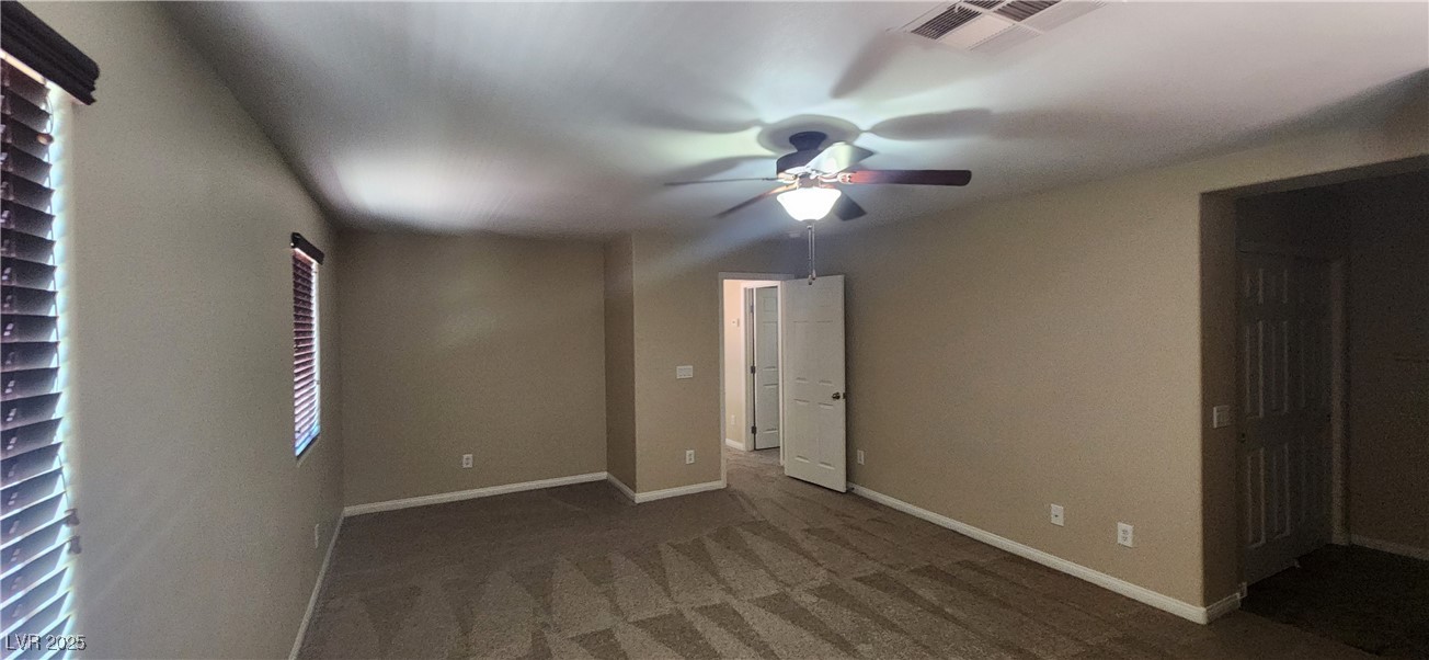 10211 Glimmering Star Drive Las Vegas, NV 89178 - Photo 10 of 33 Carpeted empty room with ceiling fan and baseboards
