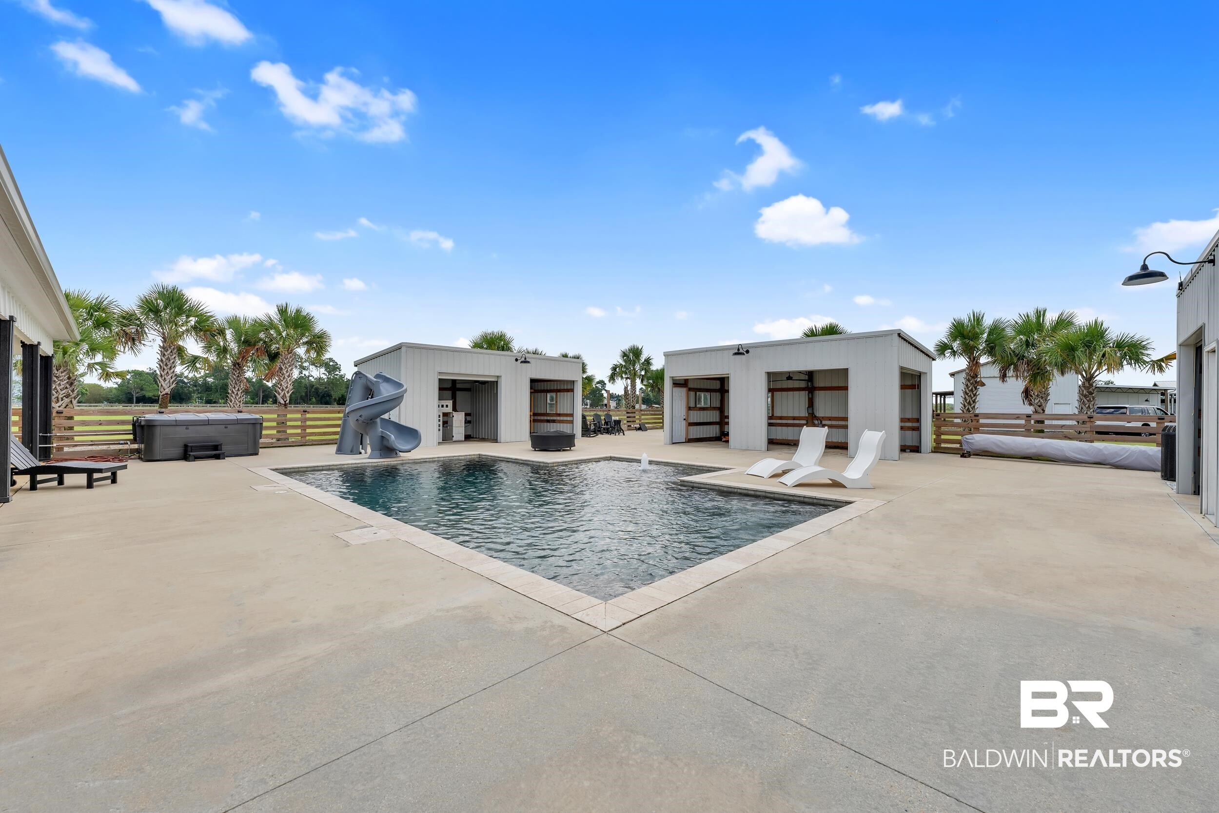 22592 Pastoral Lane Foley, AL 36535 - Photo 4 of 45 View of swimming pool with a water slide, a hot tub, and a patio