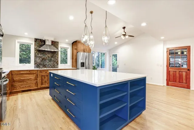 a kitchen with a stove and a wooden floor