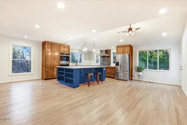 a view of a kitchen with furniture and wooden floor